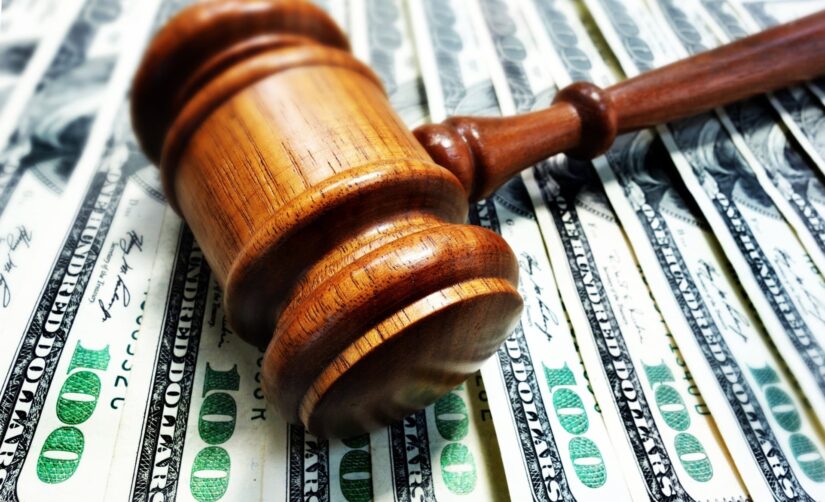 A gavel laying on cash